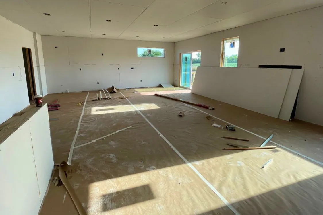 Commercial interior during early stages of drywall service work